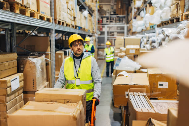 istock A small group of workers works in a wholesale warehouse, arranging cardboard boxes and packages 2042856359