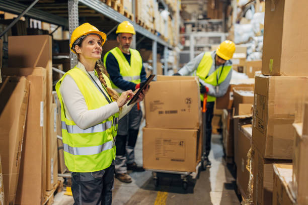 istock Female warehouse manager with digital tablet checking goods in warehouse - Wholesale, logistics, business concept 2042856906