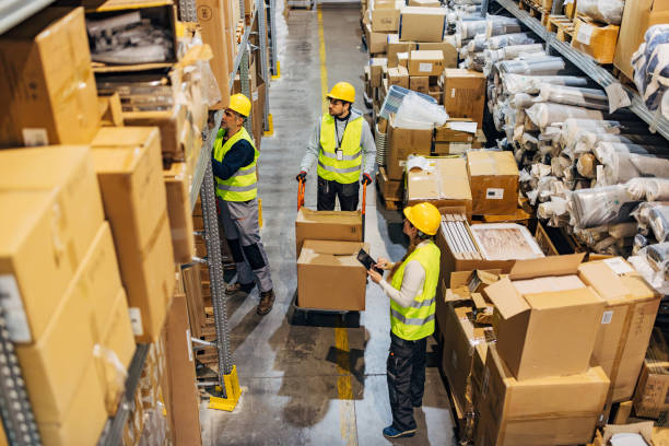 istock A woman warehouse worker reads a shipment list from a digital tablet while her colleagues prepare the shipment for shipping 2042857443
