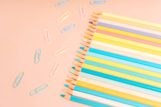 istock Colored pencils and paper clips on a beige background 2042858436