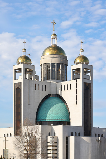 Patriarchal Cathedral of the Resurrection of Christ of the UGCC in the rays of the winter sun against the background of a blue cloudy sky. Vertical image.