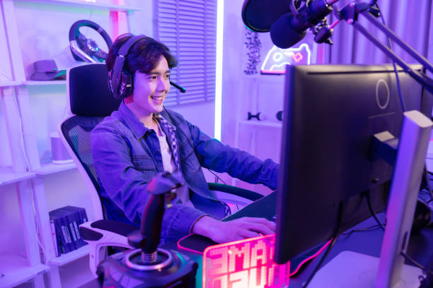 istock Male Gamer Playing PC Game with Mouse and Keyboard in Neon Game Room 2042875244