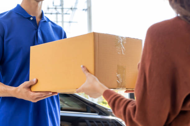 istock Close Up on Woman Received a Parcel Box From a Delivery Man or Messenger 2042875786
