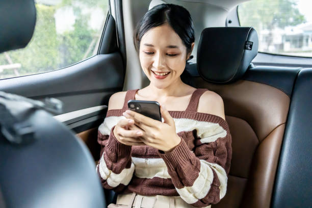 istock Asian woman in a car using a smartphone. 2042891399