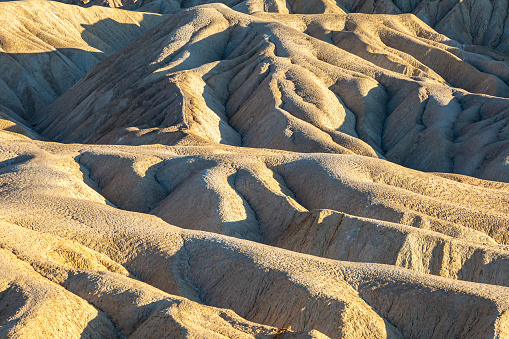 Evening light at Zabriskie Point in Death Valley, with light and shade in the ridges of rock