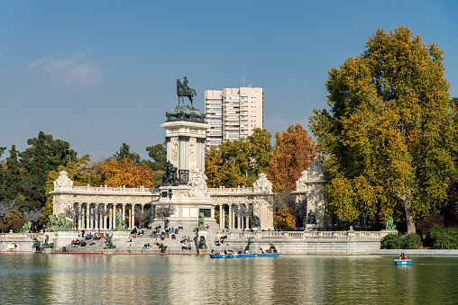 Pond next to the Monument to Alfonso XII of Spain, in the Retiro Park (Parque del Retiro) at Madrid city, Spain during autumn. Located in the center of Madrid near the Alcalá Gate, this public park is visited daily by thousands of local people and tourists.