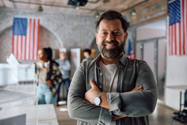 istock Confident American citizen at polling place during elections looking at camera. 2042938099