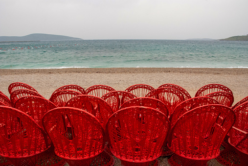 red armchairs chaise longue by the sea