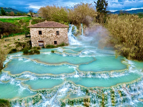 Horizontal drone shot of the hot thermal springs in Saturnia in Italy