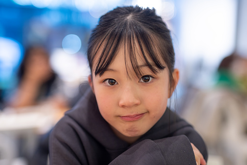 Portrait of teenage girl in cafe
