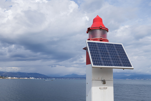 Maritime port navigation light powered by solar panel, French Mediterranean coast at Antibes near Nice and Cannes