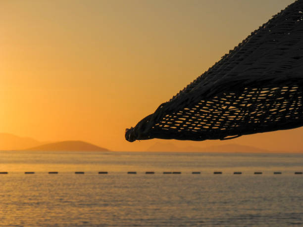 Dusk over the Sea with reed umbrella