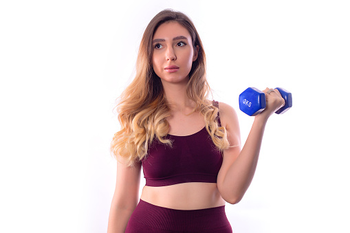 Young woman with dumbbells on the way to losing weight