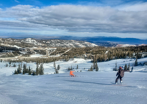 Brian Head, Utah, USA- February 19, 2024: Snowboarders on a groomed run. Brian Head ski resort, Utah.