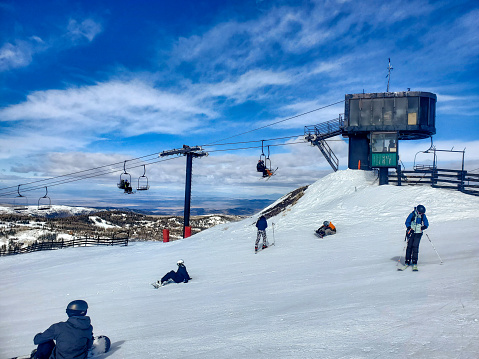 Brian Head, Utah, USA- February 19, 2024: Skiers and snowboarders at the top of a lift. Brian Head ski resort, Utah.