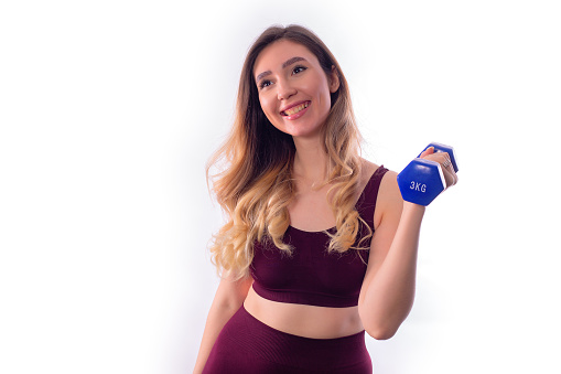 Young woman enjoying exercise with dumbbells
