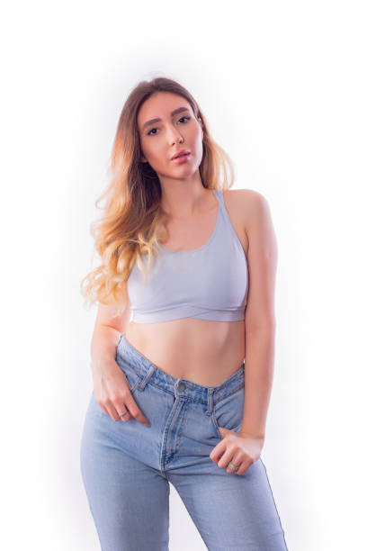Confident woman in casual clothes posing on white background