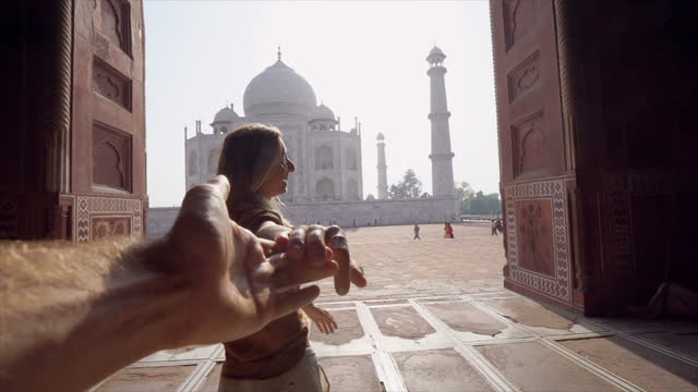 Carefree couple sightseeing the famous Taj Mahal in Agra India, Couple holding hands, Slow Motion