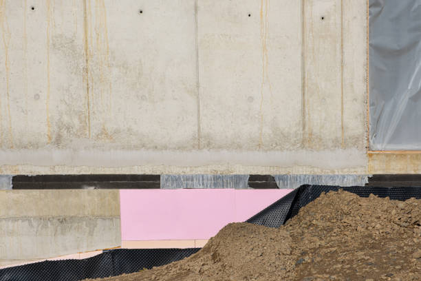 waterproof and ground  thermal insulation coatings applied on the Foundation bottom wall in a new house under construction.  PVC membrane building insulation and example Bitumen material