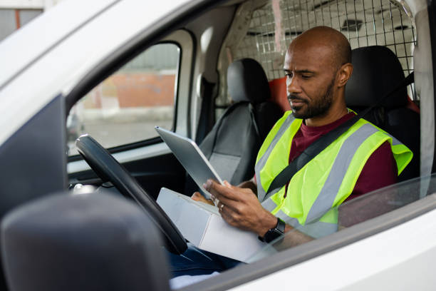 istock Delivery man using tablet and planning deliveries 2042981546