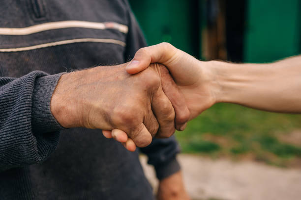 istock Senior man and young man holding hands 2042987571