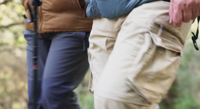 Close-Up: Senior Couple's Legs in Cargo Pants on Forest Trail