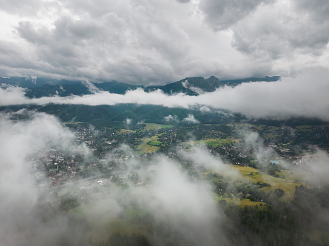 Aerial drone photo through the clouds in Zakopane, a resort town in southern Poland at the foot of the Tatra Mountains. High quality photo hub