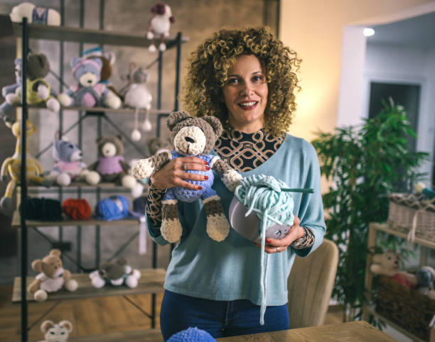 istock young woman working from home -knitting toys 2043032208