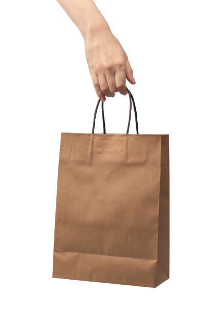 Paper bag in woman hand isolated on a white background.
