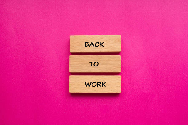 istock Back to work words written on wooden blocks with pink background 2043039687