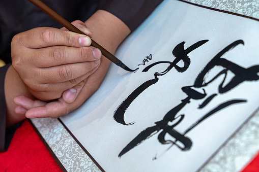 Close focus hand is writing calligraphy of Vietnamese - Nha Trang city, Khanh Hoa province