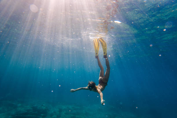istock Young woman snorkeling underwater 2043073621