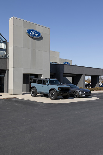 Zionsville - February 25, 2024: Ford Bronco and Mustang display at a dealership. Ford offers the Mustang and Bronco in standard and upgraded models.