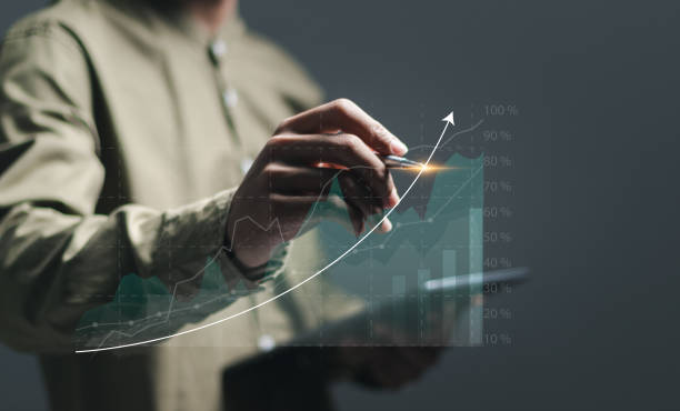istock Businessman use pen drawing up arrow for analyzes financial growth graph for long-term investment, Financial goals and global economic business planning. 2043083147