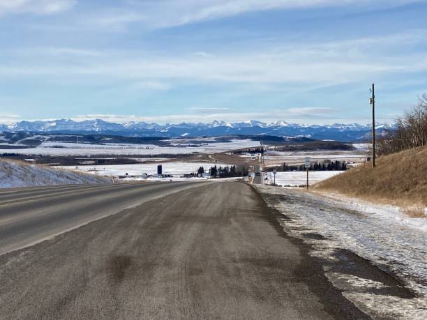 istock Highway with snow to the mountain blue sky and and mountain view 2043087919