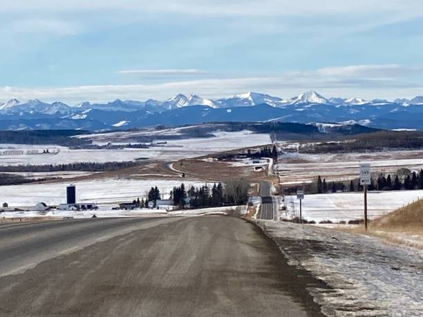 istock Highway with snow to the mountain blue sky and and mountain view 2043087932