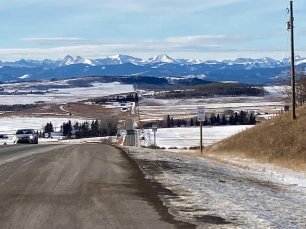 istock Highway with snow to the mountain blue sky and and mountain view 2043087935