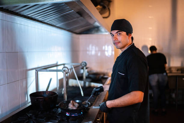 istock Portrait of a young chef man cooking a meat at restaurant kitchen 2043094323