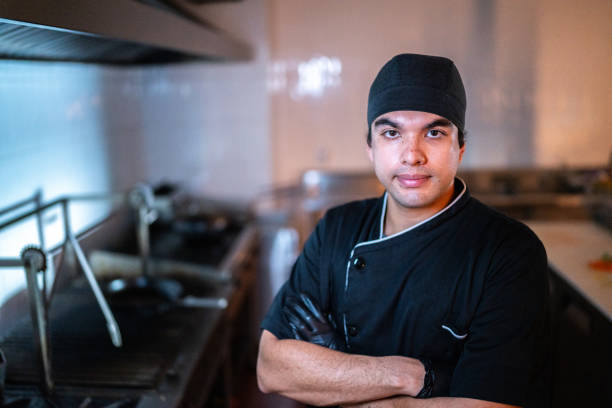 Portrait of a young chef man at restaurant kitchen
