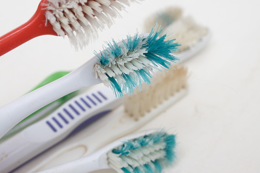 Old worn out toothbrushes with bent bristles