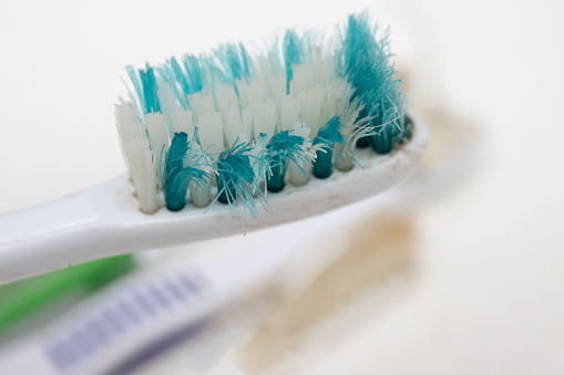 An Old worn out toothbrush with bent bristles
