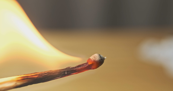 Close up of burning matches against black background