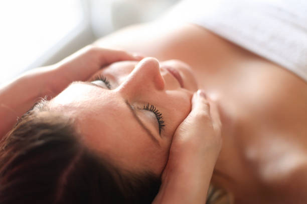 istock Young woman having a head massage in a spa 2043124054