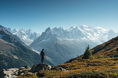 Male traveler standing with enjoying the Mont Blanc massif during trail among the French Alps at Chamonix, France