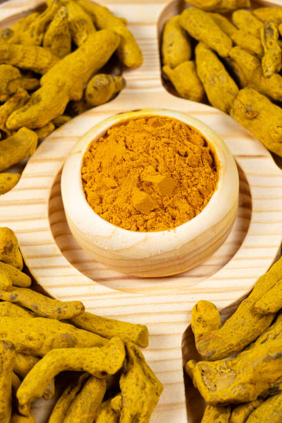 istock Turmeric powder and dried turmeric root top view. 2043140591