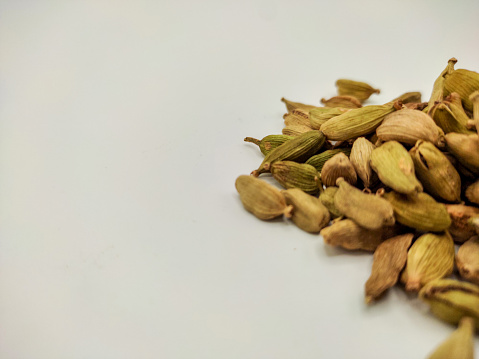 white pepper in the wooden bowl. pepper is a flowering vine in the family Piperaceae, cultivated for its fruit, which is usually dried and used as a spice and seasoning. Piper nigrum.