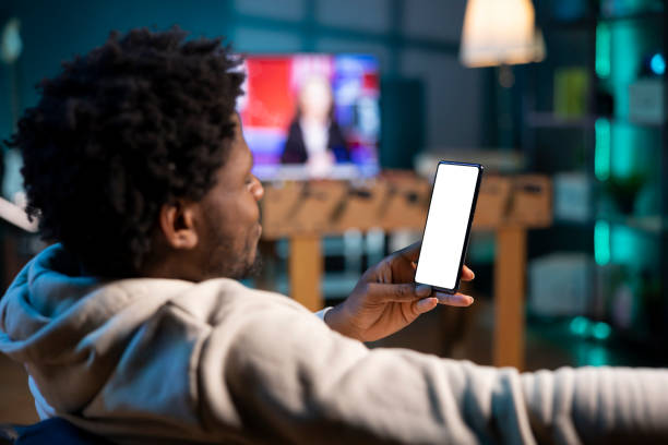 istock Man texting internet friends using mockup mobile phone at home 2043164382