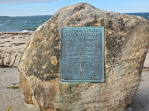 Sag Harbor, NY, USA,11.18.2023 - A plaque on a rock for Clifford J. Foster Memorial Beach in Sag Harbor, New York.