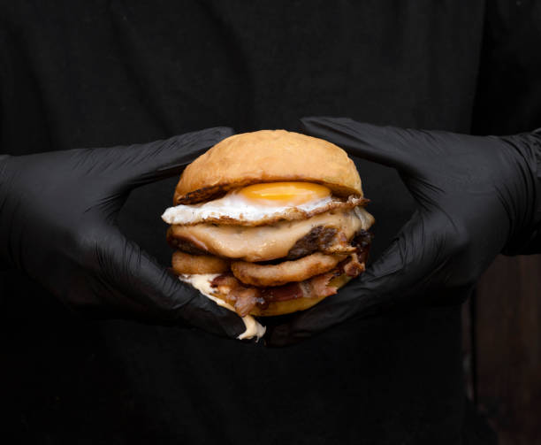 istock Chef holding a delicious burger with egg and provolone cheese 2043179109