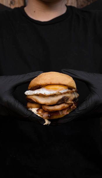 istock Chef holding a delicious burger with egg and provolone cheese 2043179646